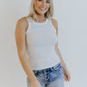 Front view of model wearing the Let's Go Tank in Ivory which features white ribbed fabric, a round neckline and thick straps.