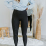 Front view of model wearing the Back To The Basics Leggings in Black which features black fabric, high waistband and straight leg pant.