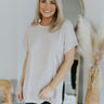 Front view of model wearing the Take It Easy Top in Natural which features natural color knit fabric, a round neckline, and short sleeves.