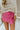 Front view of model wearing the Always On My Mind Skort that has pink fabric, a skirt overlay with shorts in the back, a front bow detail, a pink lining, and a monochromatic side zipper with a hook closure
