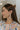 Side view of model wearing the Happy Days Earrings which features ivory and tan acrylic rectangles linked with circle shaped attachments.