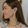 Side view of model wearing the Happy Days Earrings which features ivory and tan acrylic rectangles linked with circle shaped attachments.
