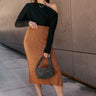 Full body view of model wearing the Audrey Light Brown Textured Midi Skirt which features light brown textured knit fabric, midi length, a slit on the side, light brown thigh length lining, and an elastic waistband.