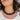 Close up of model wearing the Kendall Black Chain Link Statement Necklace that has square shaped links with a black and white marble design and a gold adjustable link closure.