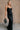 Full body front view of model wearing theElisa Black Satin Cowl Neck Maxi Dress that havs black satin fabric, maxi length,, a cowl neck, adjustable straps, and a back zipper with a hook closure.