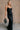 Full body front view of model wearing theElisa Black Satin Cowl Neck Maxi Dress that havs black satin fabric, maxi length,, a cowl neck, adjustable straps, and a back zipper with a hook closure.