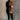 Full body view of model wearing the Freya Brown & Black Color Block Long Sleeve Sweater which features black and brown knit fabric, color-block pattern, high neckline, dropped shoulders and long sleeves with cuffs.