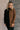 Front view of model wearing the Freya Brown & Black Color Block Long Sleeve Sweater which features black and brown knit fabric, color-block pattern, high neckline, dropped shoulders and long sleeves with cuffs.