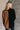 Back view of model wearing the Freya Brown & Black Color Block Long Sleeve Sweater which features black and brown knit fabric, color-block pattern, high neckline, dropped shoulders and long sleeves with cuffs.
