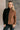 Front view of model wearing the Freya Brown & Black Color Block Long Sleeve Sweater which features black and brown knit fabric, color-block pattern, high neckline, dropped shoulders and long sleeves with cuffs.