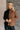 Front view of model wearing the Freya Brown & Black Color Block Long Sleeve Sweater which features black and brown knit fabric, color-block pattern, high neckline, dropped shoulders and long sleeves with cuffs.
