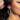 Close up view of model wearing the Stella Rhinestone Closed Large Hoop which features large closed hoops with clear rectangle and circle stones.
