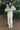 Full body front view of model wearing the Mckinley Mint Cropped Puffer Jacket that has mint green puffer fabric, a cropped waist, a front zipper with snaps, a hood, and long sleeves.
