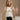 Front view of model wearing the Rebecca Taupe Patterend Shacket features taupe and white knit fabric, houndstooth print, two front slit pockets, taupe button up closure, two front buttoned chest pockets, collared neckline and long sleeves with buttoned cu