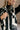 Detail view of model wearing The Jessica Black and White Checkered Vest features black and white sherpa fabric, checkered print, black zip up front closure, high neckline, front chest zipper pocket and sleeveless.