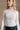Detail view of a model wearing The Elora Off White Long Sleeve Ribbed Turtleneck features off white ribbed fabric, turtleneck neckline and long sleeves.