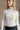 Detail view of a model wearing The Elora Off White Long Sleeve Ribbed Turtleneck features off white ribbed fabric, turtleneck neckline and long sleeves.