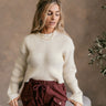 Front view of model wearing The Hannah Cream Ribbed Sweater features cream ribbed knit fabric, round neckline, dropped shoulders and long sleeves.