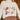 Front view of model wearing The Rachel Apres Ski Cream Sweater features off white knit fabric, ribbed hem, cursiving writing says "apres ski" in multi color threading, turtleneck neckline and long sleeves with ribbed cuffs.