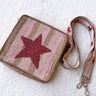 Flat lay view of the You're A Star Purse which features gold, pink and nude beads, stripe pattern with a hot pink beaded star, includes a beaded strap and zipper on the top.