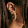 Close up view of model wearing the Enya Pearl & Gold Hoop which features open pearl hoops set in gold.