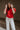 Front view of model wearing the Maddie Red Puff Sleeve Top that features red cotton fabric, a round neckline, and short bubble puff sleeves.