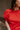 Close front view of model wearing the Maddie Red Puff Sleeve Top that features red cotton fabric, a round neckline, and short bubble puff sleeves.