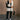 Full body front view of model wearing the Reagan White Oversized Puffer Vest that has white lightweight puffer fabric, a 3 tiered design, white lining, two pockets, a hidden zipper, snaps, a high neck and a sleeveless design.