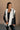 front view of model wearing the Reagan White Oversized Puffer Vest that has white lightweight puffer fabric, a 3 tiered design, white lining, two pockets, a hidden zipper, snaps, a high neck and a sleeveless design.