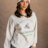 Front view of model wearing the Whistler Mountain Ski Resort Heather Grey Sweatshirt which features heather grey knit fabric, round neckline, ribbed hem and long sleeves with cuffs. Graphic says "Whistler Mountain Ski Resort" in green "For Health and Well