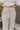Upper front view of model wearing the Let's Chill Jogger Pants that have khaki knit fabric, a two-tone ribbed waistline, waist ties, side pockets and jogger legs with a two-tone ribbed hem