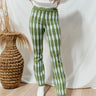 Front view of model wearing the Ready Or Not Pants that have green kit fabric with a mint geometric pattern, an elastic waistband, and wide legs.