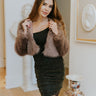 Front view of model wearing the Real Deal Faux Fur Jacket which features mocha faux-fur fabric with a satin lining, a cropped waist, a hook front closure, a round neckline, and long sleeves.