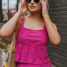 Front view of model wearing the On The West Coast Top that has fuchsia fabric with a textured line design, a peplum hem, a square neckline, and thick straps.