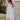 front view of model wearing The Santorini White Maxi Dress features textured off white fabric, maxi length, off white lining, tiered ruffle hem details, sweetheart neckline, ruffle straps and sleeveless.