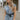 Front view of model wearing the Are You Ready Romper that has washed lightweight denim fabric, front pockets, two back pockets, a hidden front snap closure, a collar, short sleeves, and  frayed hems.