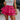Front view of model wearing the Close To You Skort which features hot pink fabric, a skirt overlay with shorts underneath, a mini-length hem, ruffled tiered details, and an elastic/smocked waistband with a tie.