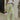 front view of model wearing the For The Record Pants that have soft light green knit fabric, two front pockets, an elastic waistband with drawstring ties, and wide legs.