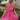 Front view of model wearing the You Have My Heart Dress which features hot pink fabric with a lining, a diagonal ruffle and pleated skirt, a halter neckline that ties around the neck, an open back, and a monochromatic side zipper.