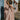 Full body front view of model wearing the Melrose Avenue Pleated Pants that have blush-colored pleated fabric, blush lining, an elastic waistband, and wide legs