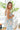 Side view of model wearing the Hello Sunshine Top that has purple, blue, orange, green, yellow and ivory fabric with a floral pattern, a peplum hem, a smocked upper, a square neckline and tie straps.
