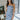 Front view of model wearing the Better This Way Dress which features light blue, dark blue and cream brocade fabric with a floral design, a midi-length hem, a front slit, a straight strapless neckline, and a monochromatic back zipper.