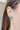 Model is wearing the Paint The Town Earring in Blue that have blue mini open shaped hoop with gold dots.