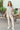 Full body front view of model wearing the Eastern Shore Top that has light grey fabric, light grey waffle-knit fabric, a scooped hem, a notched round neckline, and short sleeves