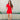 Full body view of model wearing the Dakota Denim Romper in Red which features red denim fabric, front pockets, a hidden front zipper, a collared neckline, a monochromatic belt at the waistline, and short sleeves.