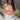 Front view of model wearing the Chasing Summer Tank in Peach which features peach knit fabric, a cropped waist, a halter neckline, an open back and a sleeveless design.