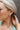 Side view of model wearing the Checkmate Earring in Mint which features turquoise and mint square beads, checkered design and mini open hoops with gold details.