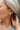 Side view of model wearing the Checkmate Earring in Mint which features turquoise and mint square beads, checkered design and mini open hoops with gold details.