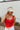 Front view of model wearing the Rida Straw Visor that has ivory woven material with a geometric design and an elastic band.
