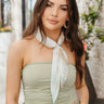Front view of model wearing the Summer Romance Scarf that features mint green, beige and white water-color pleated fabric.